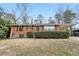 Charming brick home featuring a well-maintained lawn and a convenient carport at 1820 Arkose Dr, Atlanta, GA 30316