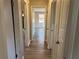 Hallway with wood-look flooring and a view into a living space with natural light at 1820 Arkose Dr, Atlanta, GA 30316