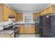 Cozy kitchen features wood cabinetry, laminate countertops, and a black refrigerator at 1820 Arkose Dr, Atlanta, GA 30316