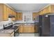 Galley kitchen with wood cabinets and black appliances at 1820 Arkose Dr, Atlanta, GA 30316