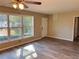 Inviting living room featuring new vinyl floors, neutral paint, and a large window offering views of the front yard at 1820 Arkose Dr, Atlanta, GA 30316