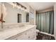 Updated bathroom with marble countertop, white vanity, and a shower/tub combo at 2536 Nw Ridgecrest Nw Dr, Kennesaw, GA 30152