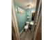 Small bathroom with teal walls and grey flooring at 3882 Parklane Dr, Clarkston, GA 30021