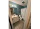 Bathroom with teal walls, white vanity, and shower/tub at 3882 Parklane Dr, Clarkston, GA 30021