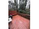 Wooden deck with bench overlooking wooded area at 3882 Parklane Dr, Clarkston, GA 30021