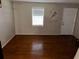 Simple living room with hardwood floors and a white door at 3882 Parklane Dr, Clarkston, GA 30021