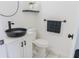 Stylish bathroom with black vessel sink and white vanity at 5055 Promenade Sw Dr, Atlanta, GA 30331