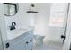 Modern bathroom with white vanity, toilet, and grey tile floor at 5055 Promenade Sw Dr, Atlanta, GA 30331