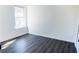 Well-lit bedroom featuring grey wood flooring and a large window at 5055 Promenade Sw Dr, Atlanta, GA 30331