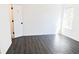 Well-lit bedroom with grey vinyl flooring and door at 5055 Promenade Sw Dr, Atlanta, GA 30331