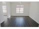 Open concept dining room with gray vinyl plank flooring and kitchen view at 5055 Promenade Sw Dr, Atlanta, GA 30331