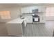 Bright kitchen features an island, stainless steel appliances, quartz countertops, and white cabinetry at 5055 Promenade Sw Dr, Atlanta, GA 30331