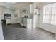 Modern kitchen with gray vinyl plank flooring and white cabinets at 5055 Promenade Sw Dr, Atlanta, GA 30331