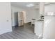 Modern kitchen with stainless steel appliances, white cabinets, and gray hardwood floors at 5055 Promenade Sw Dr, Atlanta, GA 30331