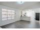 Living room with gray vinyl plank flooring and kitchen access at 5055 Promenade Sw Dr, Atlanta, GA 30331