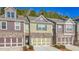 Brick front three-unit townhome with attached garages and landscaping at 86 Trailview Ln, Hiram, GA 30141