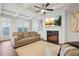 Bright living room featuring a coffered ceiling, fireplace, large windows, and comfortable seating at 86 Trailview Ln, Hiram, GA 30141