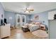 Serene bedroom with light-blue walls, hardwood floors and ceiling fan at 1300 Bridgewater Walk, Snellville, GA 30078