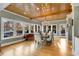 Sun-drenched dining room featuring a farmhouse table and hardwood floors at 1300 Bridgewater Walk, Snellville, GA 30078