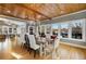 Dining room with rustic wooden table and chandelier, overlooking backyard at 1300 Bridgewater Walk, Snellville, GA 30078