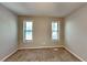 Well-lit bedroom with neutral walls and carpet flooring, plus two large windows at 4049 Maxanne Nw Dr, Kennesaw, GA 30144