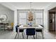 Bright dining room with chandelier and blue chairs at 4157 Alveston Dr, Atlanta, GA 30349