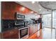 Modern kitchen with dark wood cabinets and granite counters at 400 W Peachtree Nw St # 2810, Atlanta, GA 30308