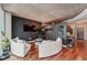 Open living area with curved sectional sofa and hardwood floors at 400 W Peachtree Nw St # 2810, Atlanta, GA 30308