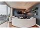 Open living area with curved sectional sofa and city view at 400 W Peachtree Nw St # 2810, Atlanta, GA 30308