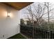 Private balcony with a black railing offering a wooded view and exterior lighting at 970 Sidney Marcus Ne Blvd # 2113, Atlanta, GA 30324