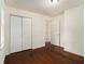 Hardwood floor bedroom with double door closet and access to hallway at 2070 Brannen Se Rd, Atlanta, GA 30316