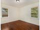 Bright bedroom with hardwood floors and two windows at 2070 Brannen Se Rd, Atlanta, GA 30316