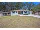 Charming white brick ranch house with teal shutters, a large yard, and a long driveway at 2070 Brannen Se Rd, Atlanta, GA 30316