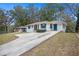 White brick ranch house with teal shutters, a large driveway and a landscaped yard at 2070 Brannen Se Rd, Atlanta, GA 30316