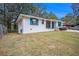 Newly renovated white brick ranch house with teal shutters and a nice lawn at 2070 Brannen Se Rd, Atlanta, GA 30316