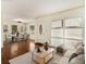 Virtually staged living room with hardwood floors, large windows, and dining area at 2070 Brannen Se Rd, Atlanta, GA 30316