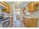 Long galley kitchen with wood cabinets and neutral colors at 396 Southern Trace Dr, Rockmart, GA 30153