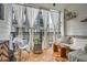 Cozy balcony with seating, wood floors, curtains, plants, and neutral decor at 400 Pratt Se Dr # 1403, Atlanta, GA 30315