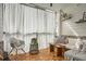 Cozy balcony with wood floors, curtains, seating, plants, and neutral decor at 400 Pratt Se Dr # 1403, Atlanta, GA 30315