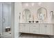 Well-lit bathroom with a double sink vanity, decorative tile flooring, and a walk-in shower at 400 Pratt Se Dr # 1403, Atlanta, GA 30315