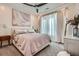 Cozy bedroom featuring a ceiling fan, a neutral color palette, and natural light from the window at 400 Pratt Se Dr # 1403, Atlanta, GA 30315
