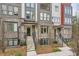 Modern townhome exterior showcasing brick facade, stairway entrance, and clean landscaping at 400 Pratt Se Dr # 1403, Atlanta, GA 30315