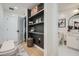 Hallway with bench, built-in shelves, and a door to a bathroom featuring stylish decor at 400 Pratt Se Dr # 1403, Atlanta, GA 30315