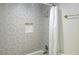 Modern bathroom features an alcove shower with mosaic wall tiles and chrome shower head at 507 Augusta Se Dr, Marietta, GA 30067