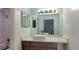 Bright bathroom with vessel sink, dark wood cabinets, and large mirror and shower area at 507 Augusta Se Dr, Marietta, GA 30067