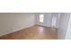 Bedroom with light hardwood floors, light walls, and a sliding glass door leading to an outside space at 507 Augusta Se Dr, Marietta, GA 30067