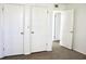 Carpeted bedroom featuring multiple closets and view to another room with wood-look floor at 507 Augusta Se Dr, Marietta, GA 30067