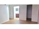 Bedroom with light hardwood floors leading into an adjoining bathroom and a closet at 507 Augusta Se Dr, Marietta, GA 30067