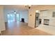 Open concept living room adjacent to the kitchen featuring stainless steel appliances, wood floors and fireplace at 507 Augusta Se Dr, Marietta, GA 30067