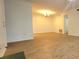 Spacious living room area with light hardwood floors, a light fixture and a neutral wall color at 507 Augusta Se Dr, Marietta, GA 30067
